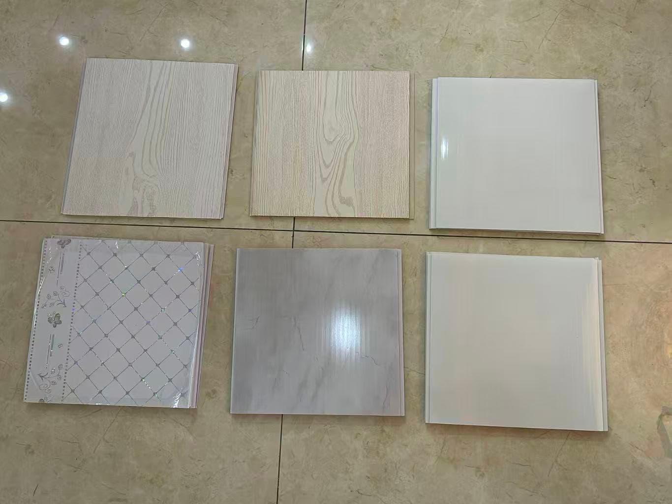 White, light wood-grain and patterned PVC ceiling panel samples