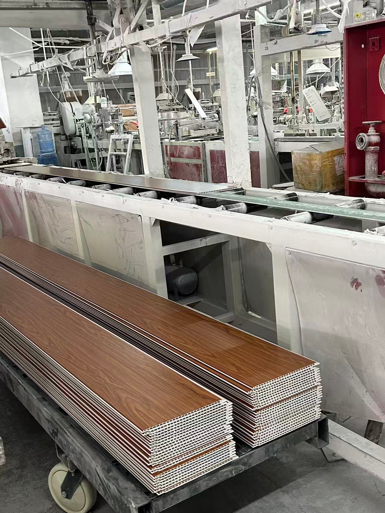 Wood-look PVC ceiling panels during factory production
